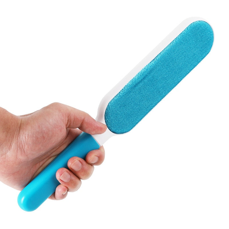 Men holds blue fur brush to remove pet hairs from dog